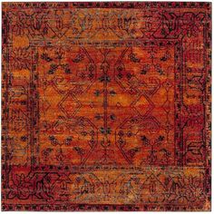 an orange, red and black rug with intricate designs on the bottom half of it