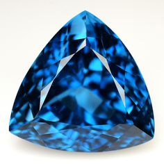 a blue diamond on a white background with the top half cut off to show it's triangular shape