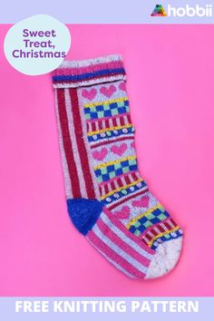 a knitted christmas sock sitting on top of a pink background with the text, free knitting pattern