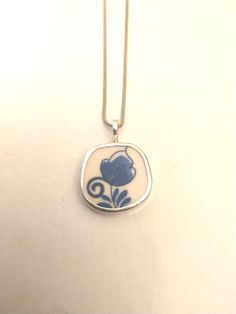 Broken China Jewelry Broken China Pendant Broken China Necklace Broken China, Pendant. sterling Silver  OOAK " Made from A DELFT Plate " 1 1/4"  Inches Long  7/8" Inches Wide Every piece of  broken china is unique and carefully handcrafted . Each piece is stamped with the artists name. All pieces are bezelled in fine silver. Bail and backing are Sterling silver . Tulip Necklace, Plate Jewelry, Artisan Jewelry Necklaces, Broken China Jewelry, China Jewelry, Broken China, Blue Pendant, Floral Pendant, Meaningful Jewelry