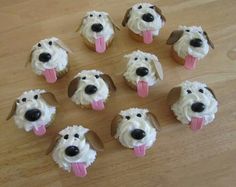 cupcakes with frosting and dog faces on them are arranged in the shape of dogs