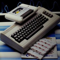 an old computer sitting on top of stacks of money next to it's keyboard