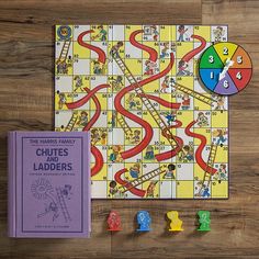 a board game with numbers and ladders next to it