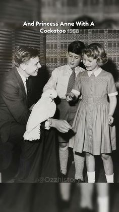 an old black and white photo of three children with a man holding a stuffed animal