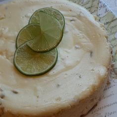 a close up of a cake on a plate with lime slices and salt sprinkles