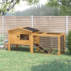 a large wooden rabbit house in the yard