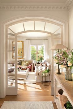 a living room filled with furniture and flowers