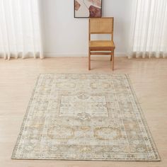 a chair sitting on top of a wooden floor next to a rug