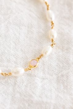 14k gold filled bracelet with 5mm - 7mm freshwater pearls wire wrapped individually with a 4mm pink opal charm Comes with an attached 1" extender chain + 3mm freshwater pearl at the end! If you would like a different length that is not listed, please contact us for a custom order! Finding Your Size We recommend using a flexible measuring tape to wrap around your wrist to find the length of your preferred fit. An alternative to this is getting a piece of string or shoelace, wrap that around your wrist, and measure the length in inches Bar Jewelry, Jewelry Workshop, Anklet Bracelet, Measuring Tape, Stamped Jewelry, Pink Opal, Birthstone Necklace, Locket Necklace, Earring Necklace