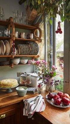 a kitchen counter with plates and bowls on it