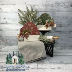 three christmas presents are stacked on top of each other in front of a wooden wall