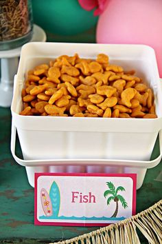 there is a bowl of fish snacks on the table