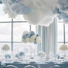 the table is set with blue and white flowers