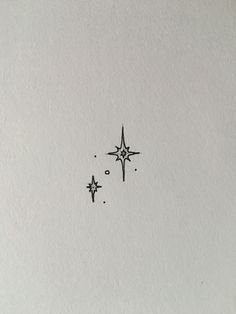 two stars are drawn in the middle of a piece of paper with ink on it