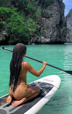 a woman sitting on top of a surfboard in the ocean