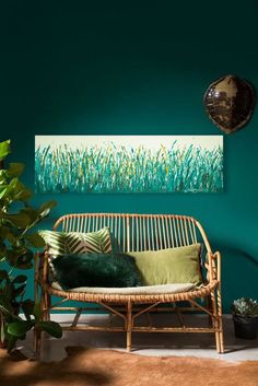 a green room with a wicker couch and potted plant in the corner, on instagram