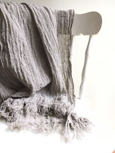 "This is a beautifully textured linen scarf. Made from gauzy, 100% pure natural taupe linen. The endings of the scarf have a decoratively frayed edges to accentuate the natural touch. A great accessory that will prove itself a timeless value. The dimensions approximately 76\"x26\" (193cm x 66cm) The shawl will be pre-washed and won't shrink anymore. Care instructions: - machine washable in gentle wash cycle - preferably lukewarm water - straighten and hang to dry - the fabric will become softer Beige Linen Bohemian Scarf, Bohemian Beige Linen Scarf, Linen Shawl, Linen Tunic Dress, Linen Scarf, Taupe Grey, Linen Scarves, Linen Tunic, European Linens