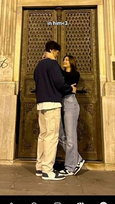 a man and woman standing in front of an ornate door with the caption'in him?