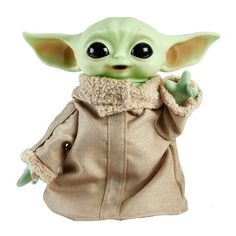 the child yoda doll is posed on a white background