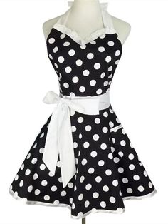 a black and white polka dot apron dress on a mannequin headdress