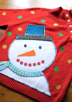 a red sweater with a snowman on it