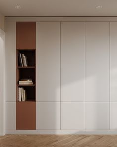 an empty room with bookshelves and wooden floors