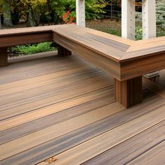 a wooden bench sitting on top of a hard wood floor next to a fenced in area