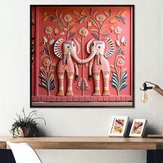 two elephants are standing next to each other in front of a red wall with flowers on it