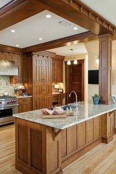 a large kitchen with wooden cabinets and an island