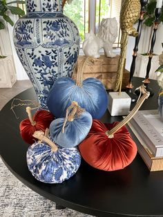 a black table topped with blue and white vases