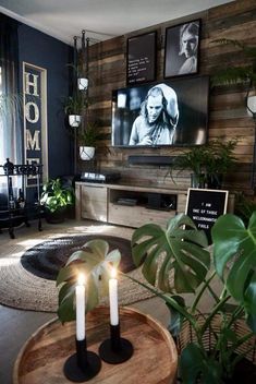 a living room filled with furniture and a flat screen tv mounted to the side of a wall