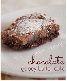 chocolate gooey butter cake on a plate with the words chocolate gooey butter cake