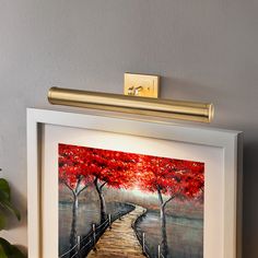 a painting hanging on the wall next to a potted plant and a light switch