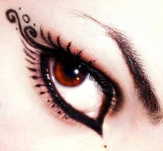 an eye with black and white designs on the iris, as well as brown eyes