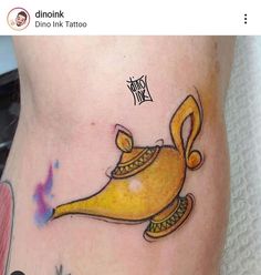 a yellow bird tattoo on the side of a woman's leg with words written below it