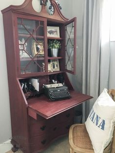 an old fashioned desk with a typewriter on it