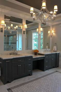 a large bathroom with double sinks and mirrors