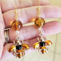 New Handmade Stunning Gold Bumblebee Earrings Earrings That Make A Statement, But Won't 'Sting' Your Budget. Beautiful 12mm Amber Beads, 4mm Faceted Crystal Beads And Amber Enameled Bee Charms 14k Yellow Gold Over .925 Sterling Silver 2.25 Inches Long 1 Inch Wide Hypoallergenic (Nickel Free) Thank You For Checking Out My Online Store. I Ship Within 24 Hours Of Cleared Payment Monday-Saturday Cute Charm Earrings, Handmade Honey Color Jewelry Gift, Handmade Honey Jewelry For Gift, Handmade Honey-colored Jewelry For Gifts, Bumble Bee Earrings, Orchid Earrings, Marcasite Earrings, Retro Earrings, Stone Dangle Earrings