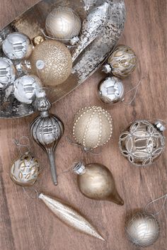 silver and gold ornaments on a wooden table