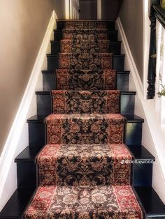 a staircase with carpeted steps leading up to the second floor