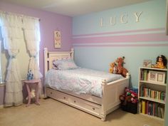 a child's bedroom decorated in pastel colors with teddy bears and bookshelves