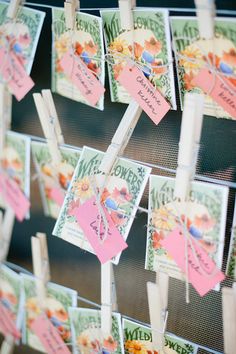 many small cards are hanging on clothes pins