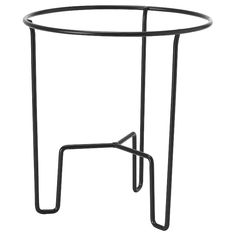 a round metal table with two legs and a black frame on the top, against a white background