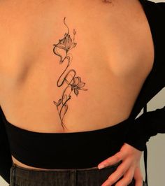 the back of a woman's shoulder with flowers on it