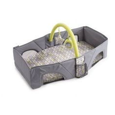 a baby crib with a yellow handle on it's head and handles in the middle