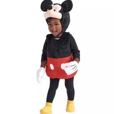 a little boy dressed in mickey mouse costume