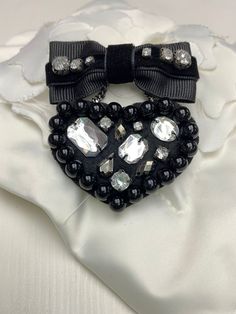 This beautiful black beaded bow tie brooch pin is suitable for informal occasions. It is also great for DIY project, dress and bag decoration. It is a nice gift for mum, wife, girlfriend, family and friends.    The condition of the brooch is as the photos.  Quantity: 1 pc brooch Colour: Black/ Silver Length: 5.2 cm Width: 7 cm Material: Felt, metal safe pin, plastic beads, polyester thread, grosgrain tape, metal ornaments, velvet ribbon, rhinestone Closure: Pin Check out our store for more trims Beaded Bow Tie, Bag Brooch, Women Brooch, Dress Brooch, Tie Brooch, Brooch Dress, Beaded Heart, Bow Women, Heart Brooch