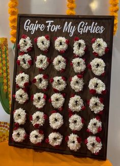 there is a sign that says gigre for my girls on it and some flowers around it