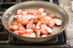 cooked sausages in a frying pan on the stove