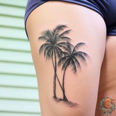 a woman's thigh with a palm tree tattoo on it